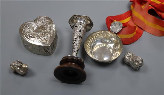 A Chinese white metal spill vase on stand, a taste vin, a Chinese spoon, two white metal boxes and a heart shaped box.